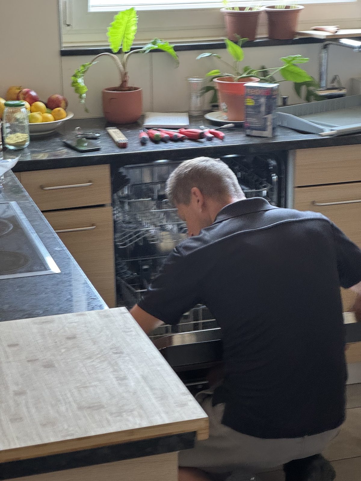 Marco Haidinger beim Einbau eines Geschirrspülers in einer Küche